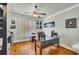 Bright home office featuring hardwood floors, custom built-ins, and a ceiling fan at 326 Carmichael Cir, Canton, GA 30115