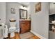 Charming powder room featuring a wood vanity, granite countertops, and stylish mirror at 326 Carmichael Cir, Canton, GA 30115