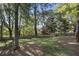 Large, private backyard featuring mature trees, a fenced perimeter, and cozy seating area perfect for outdoor enjoyment at 510 Birch Ridge Ct, Roswell, GA 30076