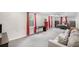 Spacious basement area features a sofa, desk, bed, and multiple windows with red drapes at 510 Birch Ridge Ct, Roswell, GA 30076