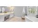 Bright bathroom featuring a soaking tub with a view and a spacious double vanity with ample storage at 510 Birch Ridge Ct, Roswell, GA 30076