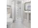 Compact bathroom with a glass-enclosed shower, pedestal sink, and tiled floors at 510 Birch Ridge Ct, Roswell, GA 30076