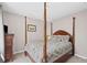 Traditional bedroom featuring a canopy bed with floral bedding and matching wooden dresser at 510 Birch Ridge Ct, Roswell, GA 30076