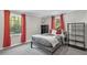 Large bedroom with a black bed frame, red curtains on large windows, and a shelving unit at 510 Birch Ridge Ct, Roswell, GA 30076