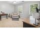 Guest bedroom featuring a comfortable chair and ottoman, desk, neutral walls, and carpeted floors at 510 Birch Ridge Ct, Roswell, GA 30076