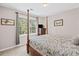 Cozy bedroom features a canopy bed, dresser, neutral walls, and natural light from a large window at 510 Birch Ridge Ct, Roswell, GA 30076