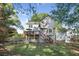 Rear exterior view showcases a deck, stairs, fenced yard and mature trees, creating a private outdoor oasis at 510 Birch Ridge Ct, Roswell, GA 30076
