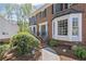 Close up on the front of a red brick home, showcasing its bay windows and landscaped entrance at 510 Birch Ridge Ct, Roswell, GA 30076