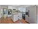 Updated kitchen offering an island, stainless refrigerator, and access to an additional room at 510 Birch Ridge Ct, Roswell, GA 30076