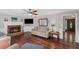 Cozy living room showcasing a brick fireplace and hardwood floors, filled with natural light at 510 Birch Ridge Ct, Roswell, GA 30076