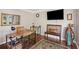Office with wood floors, desk, chair, and view of the mirror and television at 510 Birch Ridge Ct, Roswell, GA 30076