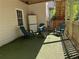 Cozy outdoor area with artificial turf, Adirondack chairs, and a small table creating a relaxing retreat at 510 Birch Ridge Ct, Roswell, GA 30076
