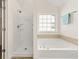 Bathroom features a walk-in shower and soaking tub at 5209 Carrington Park Dr, Powder Springs, GA 30127