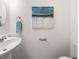 Half bathroom features blue wall art and fixtures at 5209 Carrington Park Dr, Powder Springs, GA 30127