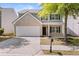 Charming two-story home featuring a brick facade, well-kept landscaping, and an attached two-car garage at 5209 Carrington Park Dr, Powder Springs, GA 30127
