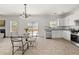 Open kitchen and dining area featuring white cabinets, a stainless steel dishwasher, and backyard access at 5209 Carrington Park Dr, Powder Springs, GA 30127