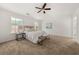 Spacious main bedroom with large windows, ceiling fan, and neutral decor at 5209 Carrington Park Dr, Powder Springs, GA 30127