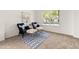 Inviting sitting area with two chairs, neutral carpet, a large window, and an accent rug at 5209 Carrington Park Dr, Powder Springs, GA 30127