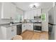 Modern kitchen with white cabinets, stainless steel appliances, granite countertops and hardwood floors at 561 Allendale Dr, Decatur, GA 30032