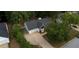 Aerial view of a one-story home with gray roof, long driveway and a bay window with black awning at 70 Summer Walk Dr, Covington, GA 30016