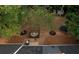Backyard with fire pit, trampoline, and mature trees, perfect for outdoor activities at 70 Summer Walk Dr, Covington, GA 30016