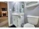 This bathroom features a vanity with storage, toilet, framed mirror, neutral wall color and views to another room at 70 Summer Walk Dr, Covington, GA 30016