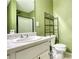 Modern bathroom featuring glass-door shower, toilet, and dark shelving for extra storage at 70 Summer Walk Dr, Covington, GA 30016