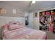 Bright bedroom with a ceiling fan, plush bedding, built in closet, and a bright window at 70 Summer Walk Dr, Covington, GA 30016
