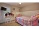 Bright bedroom with a ceiling fan, plush bedding, built in closet, and a bright window at 70 Summer Walk Dr, Covington, GA 30016