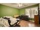Bedroom featuring a ceiling fan, dresser, dark wood floors, and a bright window at 70 Summer Walk Dr, Covington, GA 30016
