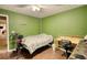 Bedroom with dark wood floors, a bright window, and a built in desk with overhead lighting at 70 Summer Walk Dr, Covington, GA 30016