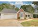 One-story home with two car garage, long drive, bay window, covered porch and manicured lawn at 70 Summer Walk Dr, Covington, GA 30016