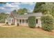 Charming home with a covered porch, brick accents and a well-manicured front yard and mature landscaping at 70 Summer Walk Dr, Covington, GA 30016