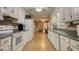 Galley style kitchen with white cabinets, laminate counter tops and stainless steel appliances at 70 Summer Walk Dr, Covington, GA 30016