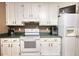Classic kitchen with white cabinets, green countertops, and white appliances at 70 Summer Walk Dr, Covington, GA 30016