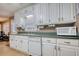 Traditional kitchen with white cabinets, green countertops, and stainless steel appliances at 70 Summer Walk Dr, Covington, GA 30016