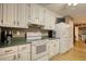 Functional kitchen featuring white appliances, ample storage, and easy access to laundry room at 70 Summer Walk Dr, Covington, GA 30016
