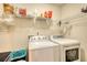 The laundry room offers a washer, dryer, wire rack shelving, and storage space at 70 Summer Walk Dr, Covington, GA 30016