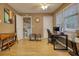 A flex room with hardwood flooring featuring a desk, computer, and laundry in the background at 70 Summer Walk Dr, Covington, GA 30016