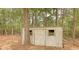 Outdoor shed with wooden door, framed windows, and surrounding trees at 70 Summer Walk Dr, Covington, GA 30016