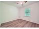 Bright bedroom featuring wood floors, a ceiling fan, and a window that brings natural light at 1718 Country Park Way, Lawrenceville, GA 30043