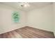Well-lit bedroom featuring wood-look flooring and a window for natural light at 1718 Country Park Way, Lawrenceville, GA 30043