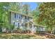 Charming two-story home with a manicured front yard and mature trees providing ample shade at 1718 Country Park Way, Lawrenceville, GA 30043