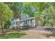 Two-story home with siding, a well-maintained yard, and mature trees at 1718 Country Park Way, Lawrenceville, GA 30043