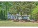 Two-story house surrounded by mature trees and grass at 1718 Country Park Way, Lawrenceville, GA 30043