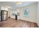 Clean, well lit kitchen features stainless appliances and wood-look flooring at 1718 Country Park Way, Lawrenceville, GA 30043