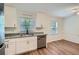 Bright kitchen featuring stainless steel appliances, granite countertops, and wood-look floors at 1718 Country Park Way, Lawrenceville, GA 30043