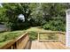 View of the backyard from the wood deck featuring a grass lawn and mature trees at 2179 Jernigan Drive Se Dr, Atlanta, GA 30315