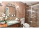 Bathroom featuring a vanity, toilet, shower with glass doors and colorful tile work at 23101 Plantation Ne Dr, Atlanta, GA 30324