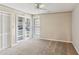 Bedroom featuring a ceiling fan, built-in shelving unit, and window with blinds at 23101 Plantation Ne Dr, Atlanta, GA 30324